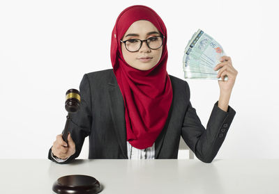 Portrait of a young woman against white background