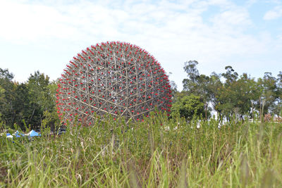 View of flower trees on field against sky