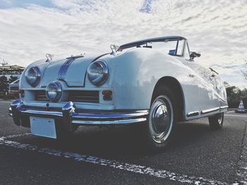 Vintage car on road against sky