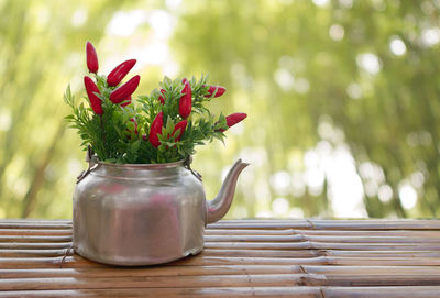 Close-up of red rose flower vase on table