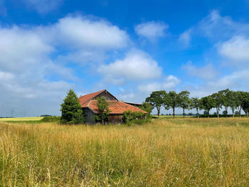 House on field against sky