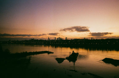 Scenic view of lake against sky at sunset