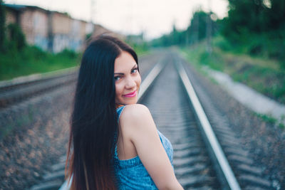Young woman on railroad tracks