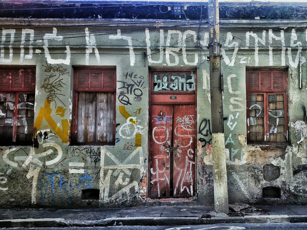 architecture, built structure, building exterior, old, door, wall - building feature, weathered, closed, entrance, art and craft, graffiti, brick wall, abandoned, wall, deterioration, window, art, house, damaged, run-down