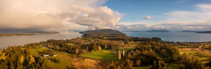 Panoramic aerial view of lummi island and a rainbow in the distance. 