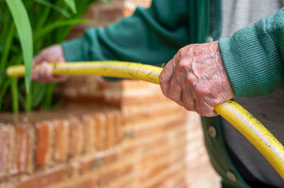 Cropped hand of man repairing bicycle