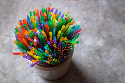 Close-up of drinking straws in container