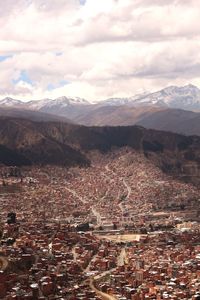 Aerial view of illuminated cityscape against sky
