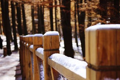 Close-up of wooden fence in snow