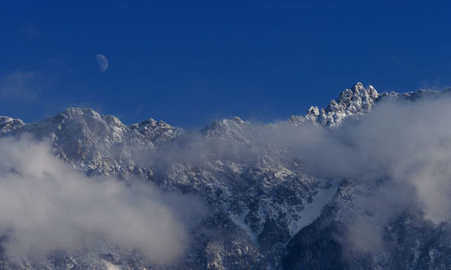 Low angle view of mountain against blue sky