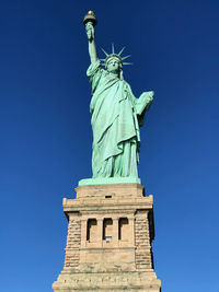 Low angle view of statue of liberty against sky