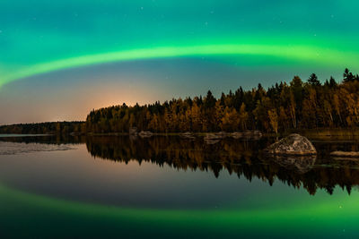 Scenic view of lake against sky at night