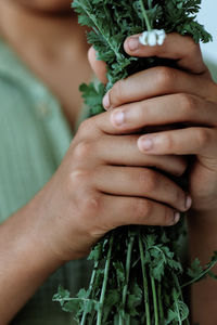 Midsection of man holding plant