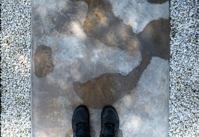 Low section of person standing on street