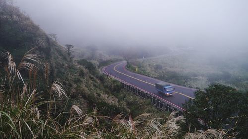 High angle view of vehicles on road against sky