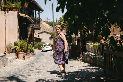 Woman standing by plants