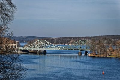 View of bridge over river against cloudy sky
