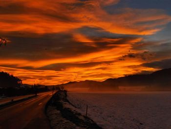 Scenic view of road against sky during sunset