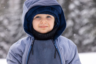 Portrait of smiling young woman standing outdoors