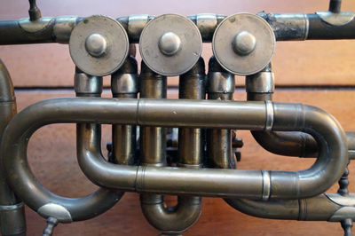 Cropped image of tenor horn by wall