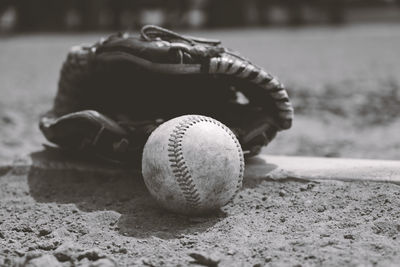 Close-up of baseball in glove on field