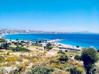 High angle view of bay against blue sky