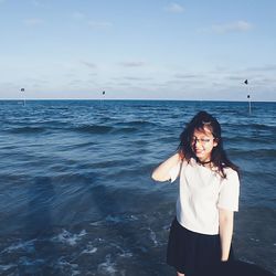 Rear view of woman standing on beach
