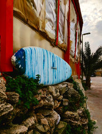 Houses by rocks against blue wall