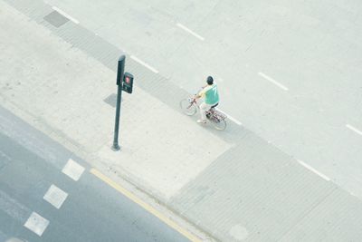 High angle view of people riding bicycle on road