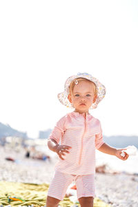 Portrait of cute girl standing against white background