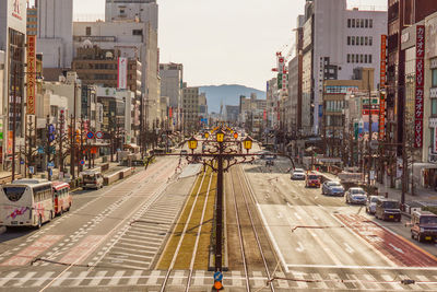 View of city street and buildings against sky