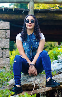 Portrait of young woman sitting outdoors