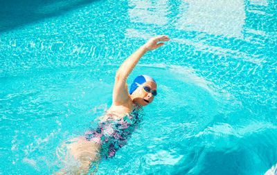 High angle view of woman swimming in pool