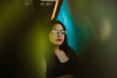 Portrait of young woman relaxing on hammock