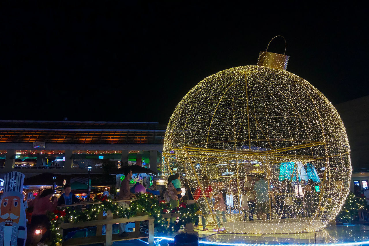 ILLUMINATED FERRIS WHEEL IN CITY AT NIGHT