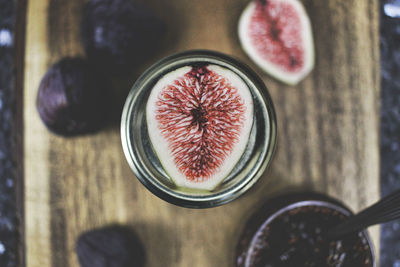 Directly above shot of halved fig in jar