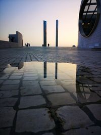 Reflection of building in puddle