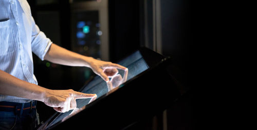 Midsection of man working in kitchen