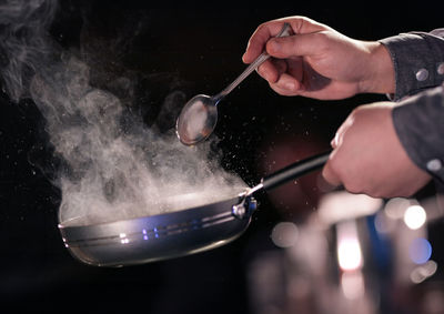 Cropped hand of man preparing food
