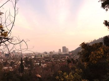 Cityscape against sky at sunset