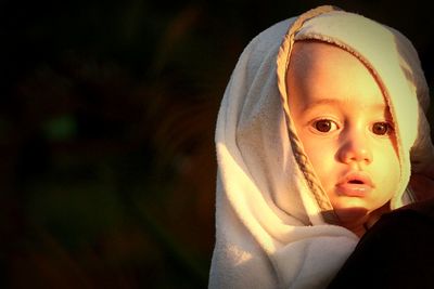 Close-up portrait of cute baby boy wearing headscarf
