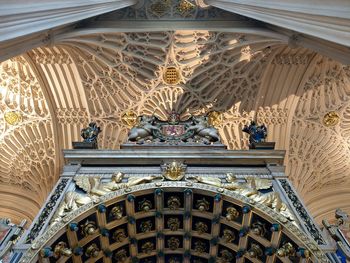 Low angle view of sculptures on ceiling of building