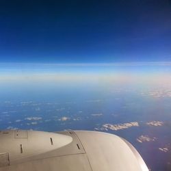 Cropped image of airplane flying in sky