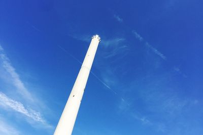 Low angle view of vapor trail against blue sky