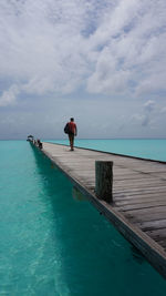 Man standing on sea against sky