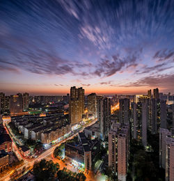 High angle view of illuminated buildings against sky during sunset