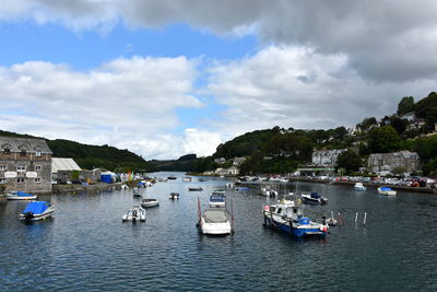 Sailboats moored on sea against sky