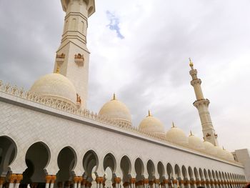 Low angle view of building against cloudy sky