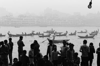 People by boats over canal