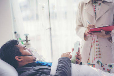 Midsection of man using mobile phone